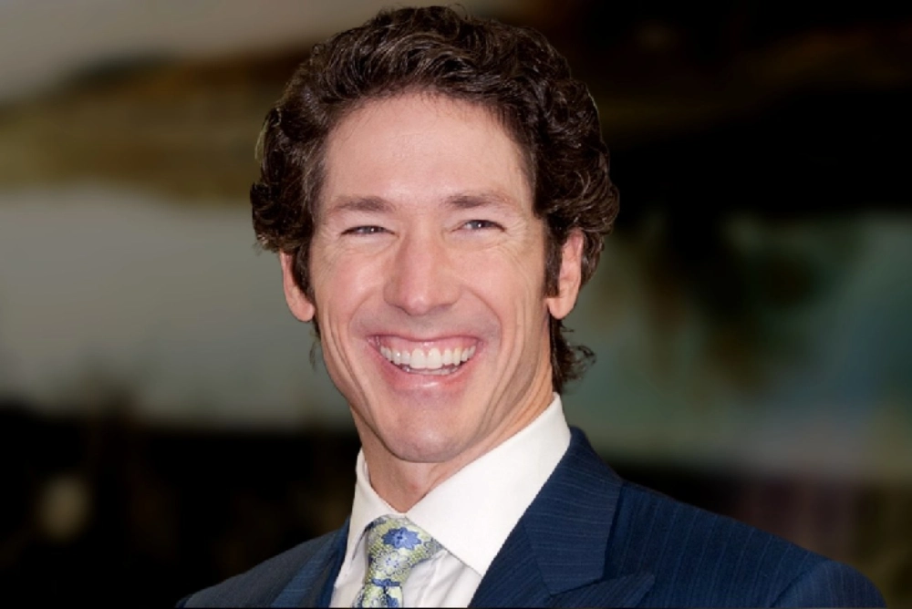 Joel Osteen Net Worth – A high-quality image of Joel Osteen, a well-known pastor, author, and televangelist, captured with a bright smile at a public event.