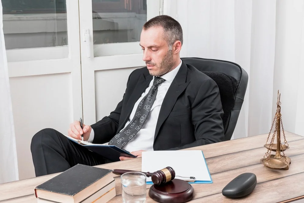 Personal injury attorney reviewing legal documents with gavel and scales of justice