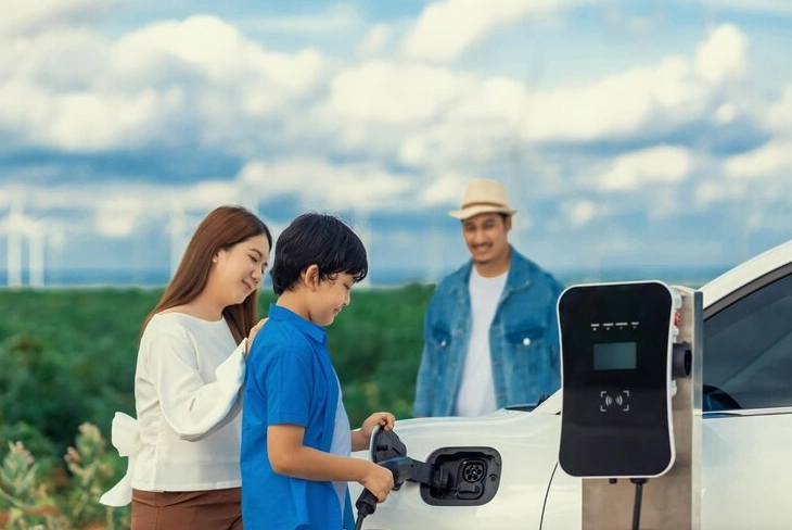 Electric vehicles charging at eco-friendly station.