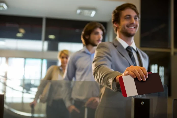 Business traveler at airport gate after booking last minute business class tickets to Europe for a luxury flight.