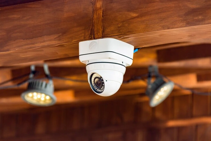 Mini dome cameras on ceiling for discreet security surveillance.