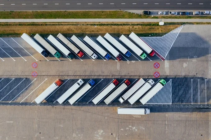 Aerial view of semi-trucks parked at a loading dock. 