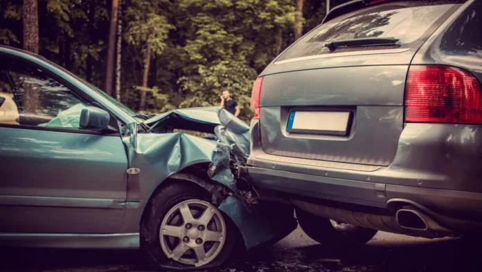 Crashed car with visible damage after a car accident on a busy road.