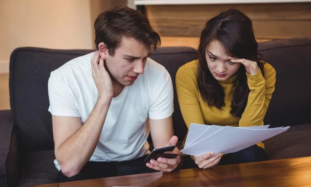 Worried parents reviewing legal documents after Teenagers Are Arrested, seeking legal advice for juvenile defense.