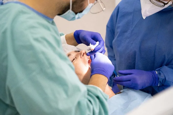 Dental professionals conducting a detailed procedure