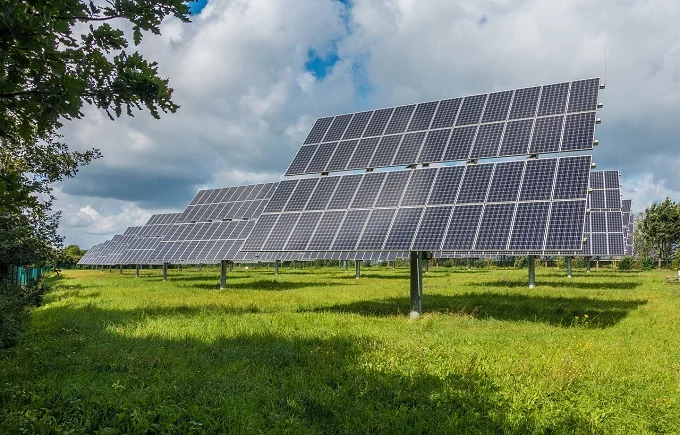 Solar panel installation in a green field for sustainable backup power.