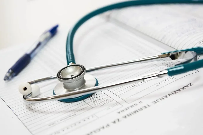  A stethoscope lying on top of patient medical records.