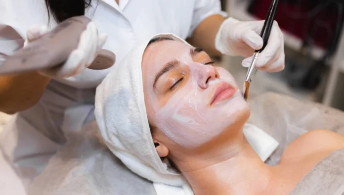 Facial beauty treatments at spa with skincare products.