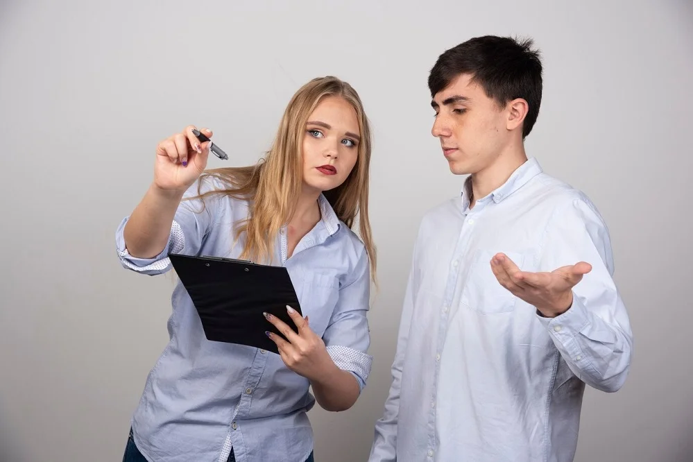 Two people discussing accident details and documenting evidence after an accident to ensure safety and legal protection.