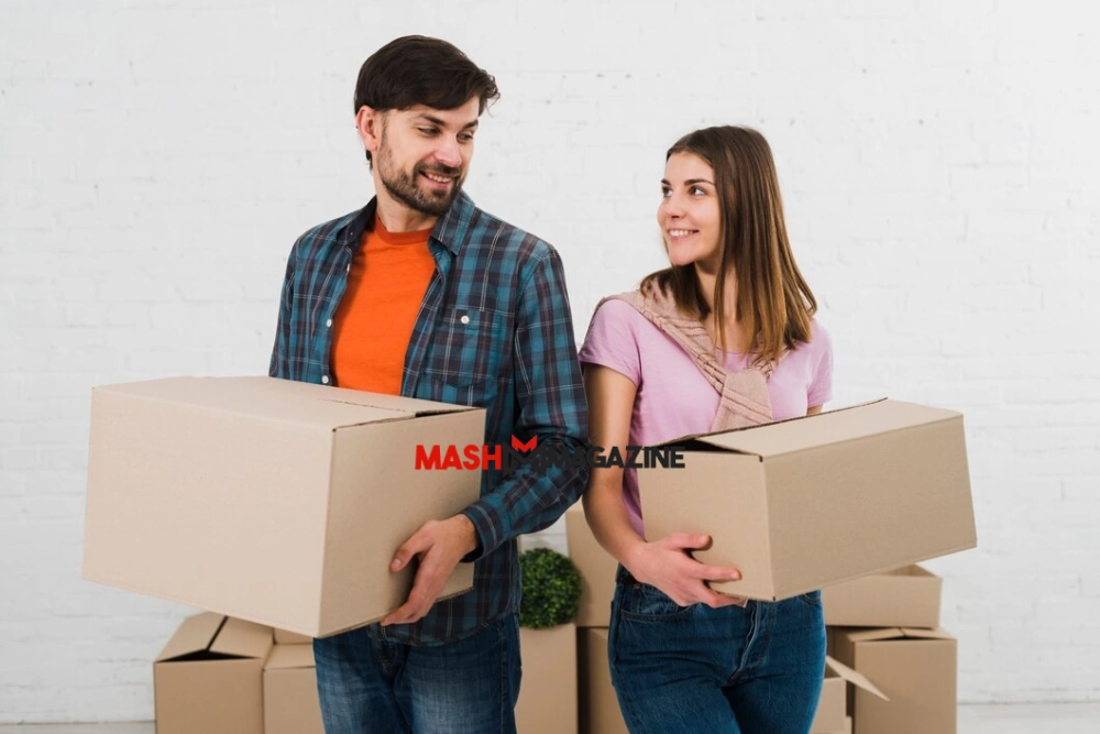 Young couple packing boxes in their new home, preparing for Moving from One Place to Another with organized lists and essentials in hand.